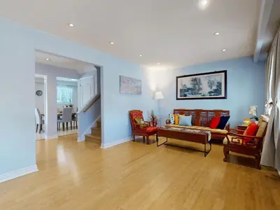 a living room with a couch and chairs at Cozy Queen room with Shared Bath near Seneca Finch 404 in Toronto