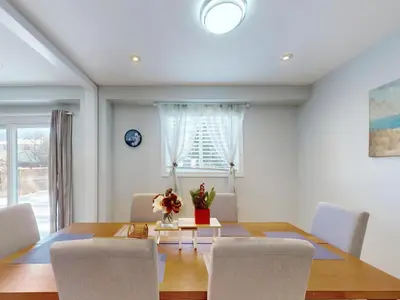 a dining room with a table and chairs at Cozy Queen room with Shared Bath near Seneca Finch 404 in Toronto