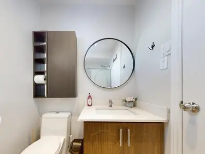 a bathroom with a sink and a mirror at Cozy Queen room with Shared Bath near Seneca Finch 404 in Toronto