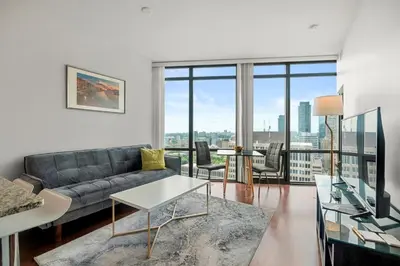 a living room with a couch and a table at 1 Bedroom Condo Burano Downtown Toronto in Toronto