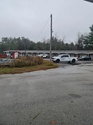 a parking lot with cars parked in front of a building at Skyways Motel in Gravenhurst