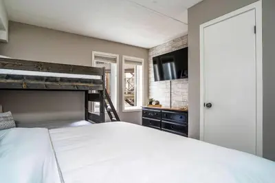 a bedroom with a large white bed and a window at Easy Rider Chalet Steps to Lift & Blue Village in Blue Mountains
