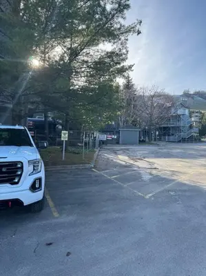 a white truck parked in a parking lot at Easy Rider Chalet Steps to Lift & Blue Village in Blue Mountains