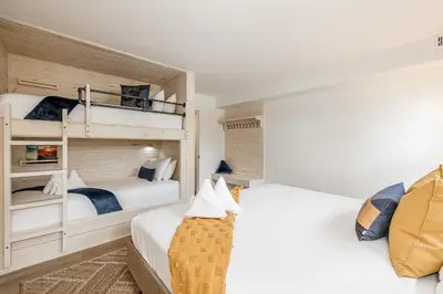 two beds in a room with two bunk beds at Lift Side Luxury Newly renovated walk to village in Blue Mountains