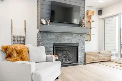 a living room with a couch and a fireplace at Lift Side Luxury Newly renovated walk to village in Blue Mountains