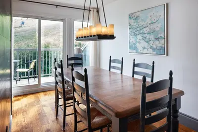 a dining room with a wooden table and chairs at First Tracks Ski-In Ski-Out & Walk to Village in Blue Mountains