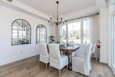 a dining room with a table and white chairs at Blue Mtn Village Retreat Walk to Blue - Shuttle in Collingwood