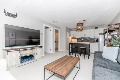a living room with a couch and a table at Alpine Cove - Condo in Collingwood - Sleeps 6 in Collingwood