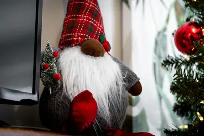a stuffed santa claus toy next to a christmas tree at South Wind - Modern Condo in Collingwood - Sleep 5 in Collingwood