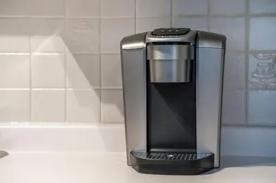 a black and silver coffee maker sitting on a counter at Tranquility Oasis Ski-In Out Hot Tub Shuttle in Blue Mountains