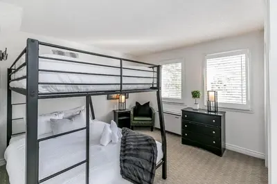 a bedroom with a bunk bed and a desk at Mountain Peaks Ski-In-Out Pool Shuttle in Blue Mountains