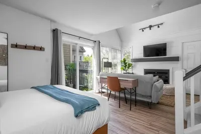 a bedroom with a bed and a desk and a television at Arrowhead Retreat Ski-In-Out Pool Shuttle in Blue Mountains
