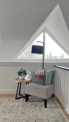 a room with a chair and a table with a window at Arrowhead Retreat Ski-In-Out Pool Shuttle in Blue Mountains