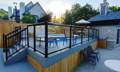 a deck with a table and chairs on it at Mountain View Ski-In-Out Pool Shuttle to Blue in Blue Mountains