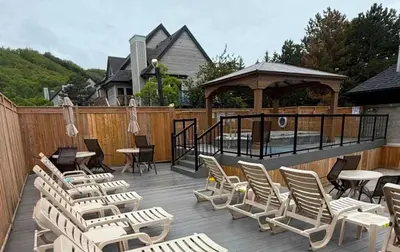 a deck with chairs and tables and a gazebo at Blue Haven Ski-In-Out Pool Hot Tub Shuttle in Blue Mountains