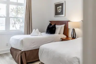 a hotel room with two beds and a window at Rivergrass Oasis Across from Blue Mtn Hot Tub in Blue Mountains