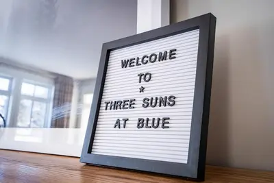 a sign that says welcome to three wins at blue at Three Suns Across Blue Mtn Hot Tub & Shuttle in Blue Mountains