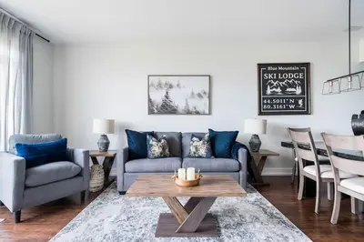 a living room with a couch and a table at The Blue - Walk to the Village Shuttle & Hot Tub in Blue Mountains
