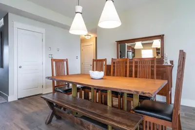 a dining room with a wooden table and chairs at Bears Den - Hot Tub - Ski Views - Walk to Village in Blue Mountains