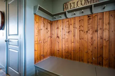 a kitchen with wood paneled walls and a door at Bears Den - Hot Tub - Ski Views - Walk to Village in Blue Mountains