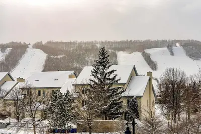 a house with snow on the roof of it at Sierra Point - Walk to the Blue - Outdoor Pool in Blue Mountains