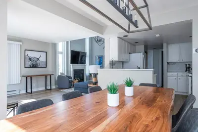 a kitchen and dining room with a wooden table and chairs at Sierra Point - Walk to the Blue - Outdoor Pool in Blue Mountains