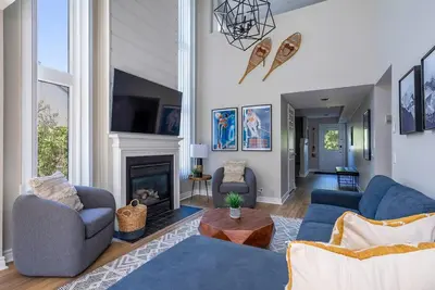 a living room with two blue couches and a fireplace at Sierra Point - Walk to the Blue - Outdoor Pool in Blue Mountains