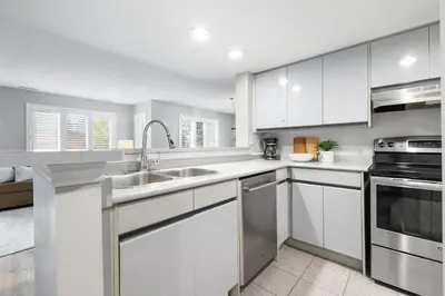 a kitchen with white cabinets and stainless steel appliances at Sierra Heights - Steps to Blue Mountain Village in Blue Mountains
