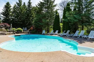 a large swimming pool with chairs and a bunch ofitures at Sierra Lookout - Steps to Blue Mountain Village in Blue Mountains