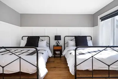 a bedroom with two beds and a window at View to Blue - Walk to the Village Mountain Views in Blue Mountains