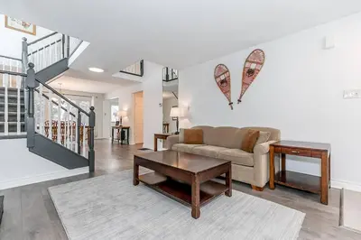 a living room with a couch and a table at Snow Pine - 10 minute drive to Blue in Collingwood