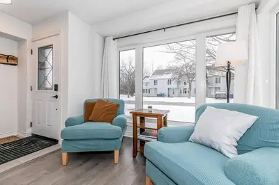 a living room with two chairs and a window at Snow Pine - 10 minute drive to Blue in Collingwood