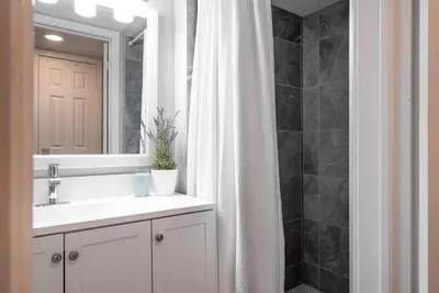 a bathroom with a sink and a shower curtain at Memory Lane - Walk to the Village - Sleeps 10 in Blue Mountains