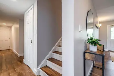 a hallway with a stairwell with a mirror and a stairwell at Memory Lane - Walk to the Village - Sleeps 10 in Blue Mountains