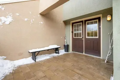 a bench sitting outside of a house with snow on it at The Mountain House - Walk to the Village in Blue Mountains