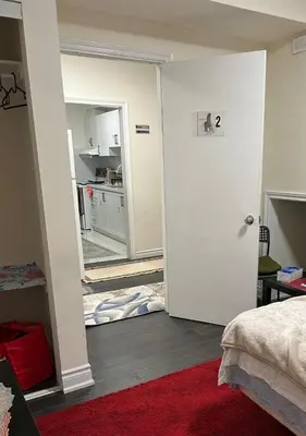 a room with a white door and a kitchen at V-Swim Suite-2 in Toronto