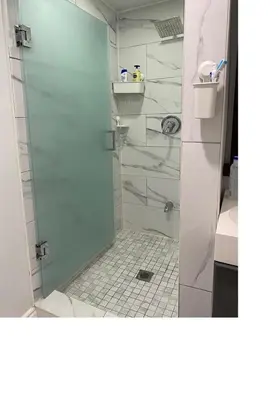 a shower with a glass door in a bathroom at V-Swim Suite-3 in Toronto