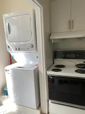 a kitchen with a white refrigerator and a stove at V-Swim Suite-1 in Toronto