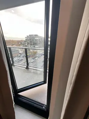 an open window with a view of a city street at Serene Cozy 1BDRM Condo near Sherway Mall, Lakeshore, & Airport in Toronto