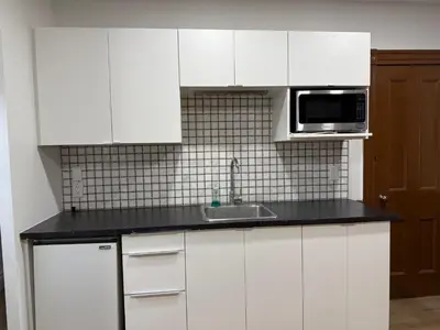 a white kitchen with a sink and a microwave at Downtown Residence Room 3 in Guelph
