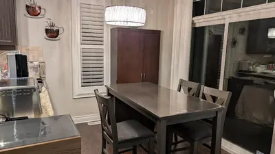 a kitchen with a table and chairs in a kitchen at Bright ensuite with WiFi Parking available in Markham