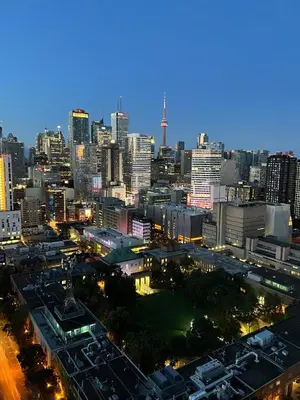 a view of a city skyline at night at Deluxe Suites & Towers Downtown Toronto in Toronto