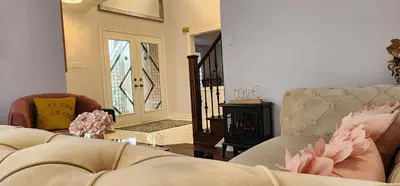 a living room with a couch and a wood stove at Modern Cozy Nook in Brampton