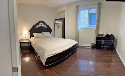 a bedroom with a large bed and a window at M2 Private cozy bedroom in Mississauga