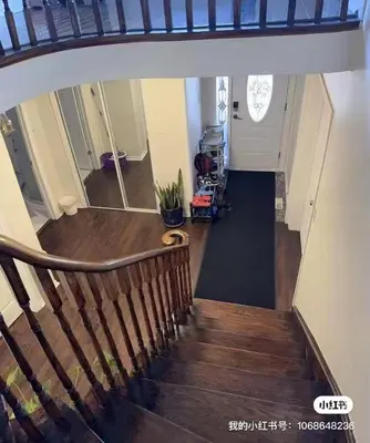 a hallway with a wooden staircase with a stair case at M2 Private cozy bedroom in Mississauga