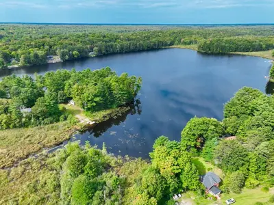 an aerial view of a lake with trees at Lakefront Muskoka Cottage with Fire Pit and BBQ in Port Carling