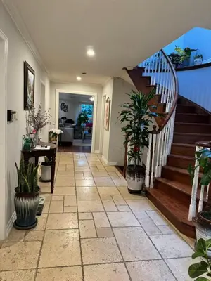 a hallway with stairs and potted plants in a house at 203 Comfortable private bedroom on second floor in Mississauga