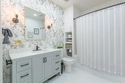 a bathroom with a toilet and a sink and a mirror at Renovated Church Hamilton! Sleeps 10 Overnight! in Hamilton