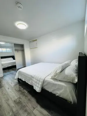 a bedroom with a large bed in a room at Konia Abode in Orangeville