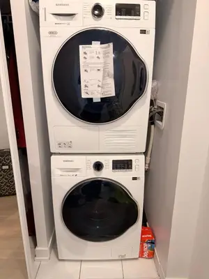 a white washer and dryer stacked on top of each other at Uniqueplace in Vaughan